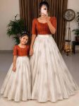 MODERN RANGOLI CRUSH SEQUENCE EMBROIDERY AND STYLISH BHUNGALI (PIPE) WORK MOTHER DAUGHTER SET RUST AND WHITE